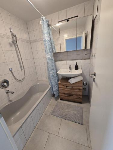 a bathroom with a tub and a sink and a shower at Ferienhof Weitblick in Oy-Mittelberg