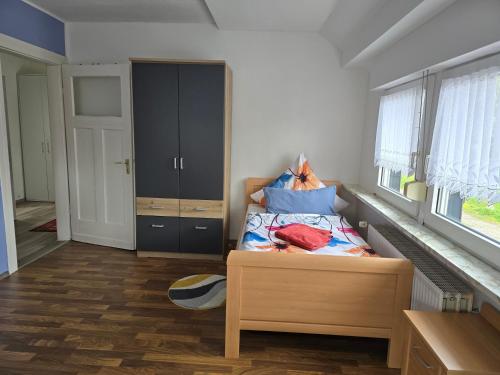 a small bedroom with a bed and a closet at Ferienwohnung Claudia in Lathen