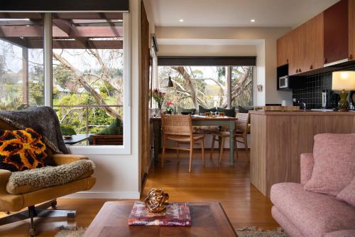 a living room with a kitchen and a dining room at Treehouse Spa Villa - Unique & Secluded Retreat in Daylesford in Daylesford