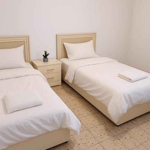 two beds sitting next to each other in a bedroom at הבית בלב העתיקה in Safed