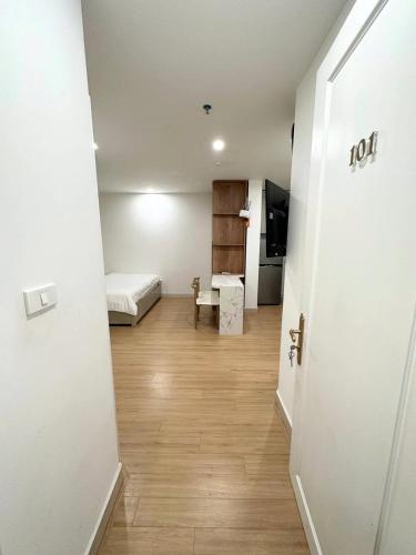 a room with a bed and a room with a door at Hibiki Apartment in Hanoi