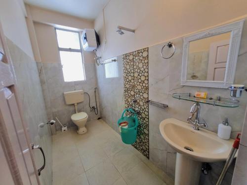 a bathroom with a sink and a toilet at Breeze Vale Homestay in Shillong