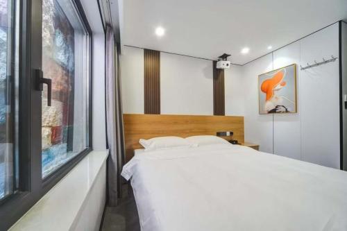 Katil atau katil-katil dalam bilik di Jiumi Hutong Homestay