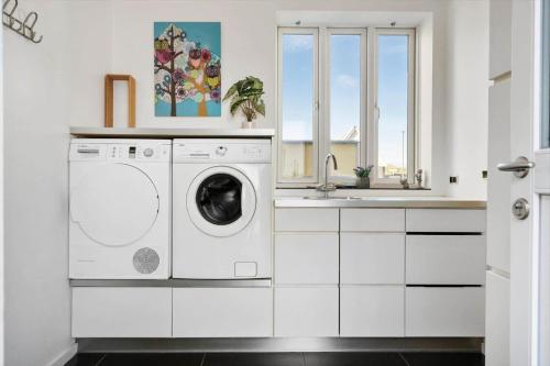 a white laundry room with a washer and a sink at 723-Thyboron-Jagtvej-4 in Thyborøn