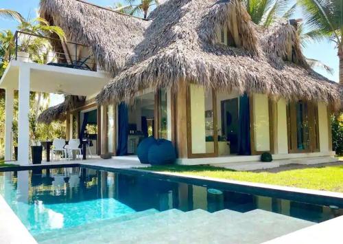 a villa with a swimming pool and a resort at Beautiful Caribbean Villa Coson Beach in Las Terrenas