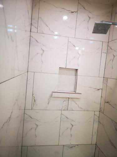 a bathroom with white marble walls and a window at Beautiful Caribbean Villa Coson Beach in Las Terrenas