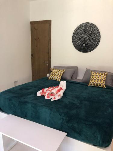 a large bed with a green blanket on it at Beautiful Caribbean Villa Coson Beach in Las Terrenas