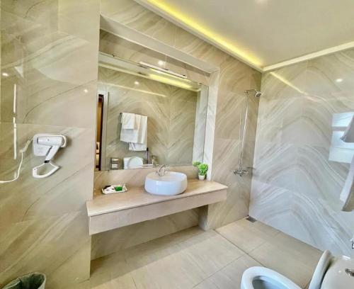a bathroom with a sink and a shower at Holiday Inn islamabad in Islamabad