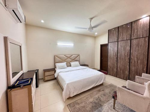 a bedroom with a bed and a tv and a couch at Holiday Inn islamabad in Islamabad