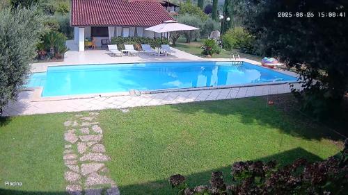 a swimming pool in the backyard of a house at Villetta BLUE GARDEN in Sonnino