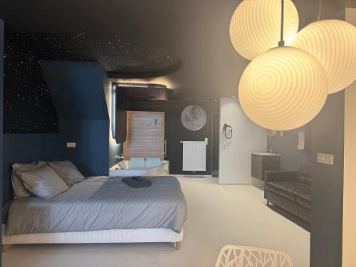 a bedroom with a bed and two large lights at Capsule Moonlight - Jacuzzi - Sauna - Ecran 100" - PS5 in Mons