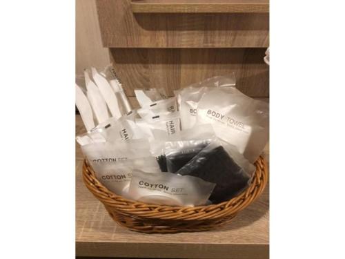 a basket filled with white items on a shelf at Hotel IL FIORE Kasai in Tokyo