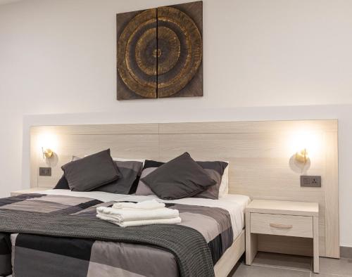 a bedroom with a bed with two towels on it at Guesthouse No. 48 in Msida