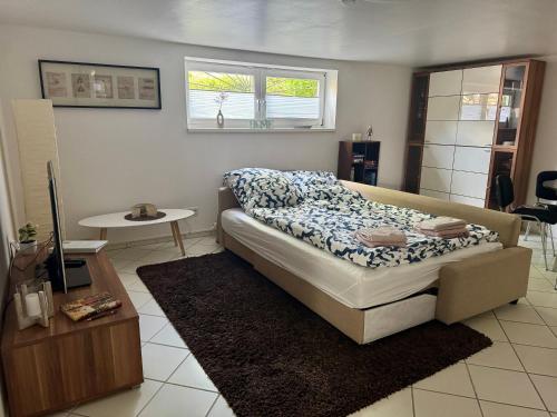 a bedroom with a bed and a table in it at FeWo Butzbachliebe in Butzbach
