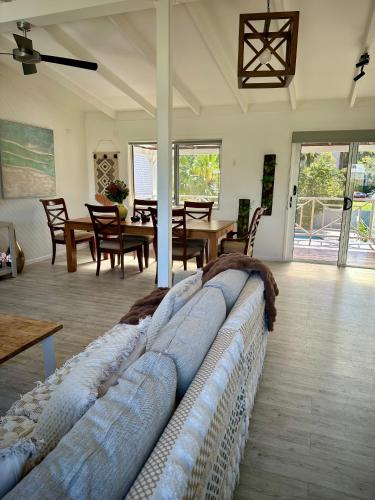 a large couch in a living room with a table at One Bedroom with shared bathroom and kitchen in Gold Coast