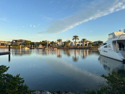 a boat is docked in a river with houses at One Bedroom with shared bathroom and kitchen in Gold Coast