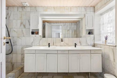 a white bathroom with a sink and a mirror at LK2169-Lokken-Sondergade-25-A in Løkken
