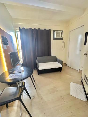 a living room with a couch and a table at Selah Lofts Hotel in Manila