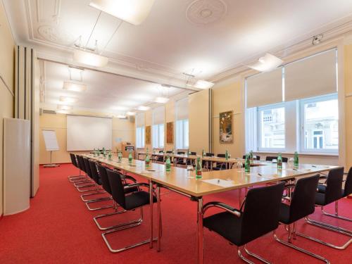 a large conference room with a long table and chairs at Hotel Kaiserhof Wien in Vienna