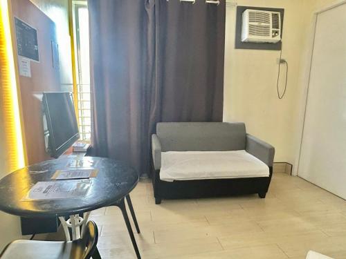 a small room with a chair and a table at Selah Lofts Hotel in Manila
