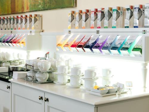 a kitchen counter with white cups and utensils at Hotel Kaiserhof Wien in Vienna
