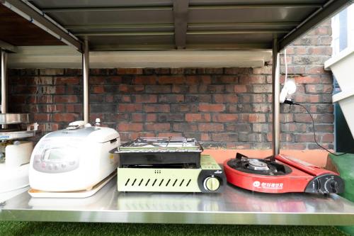 a grill and a toaster sitting on a table at Chun cheon Bongstay 2nd Floor in Chuncheon