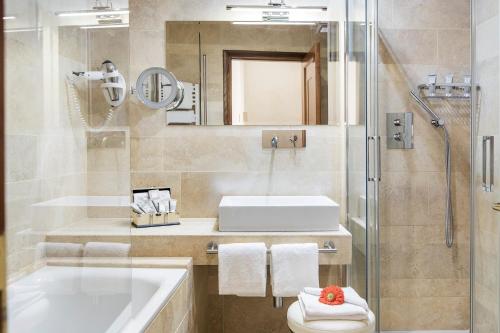 a bathroom with a sink and a toilet and a shower at Hotel Barocco in Rome