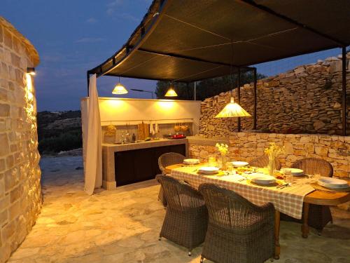 a table and chairs in a kitchen with a table at For a couple - beautiful sea view in Postira