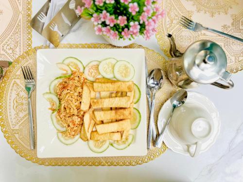 a plate of food on a table with a plate of food at Presken Hotel @Villa in Ikeja