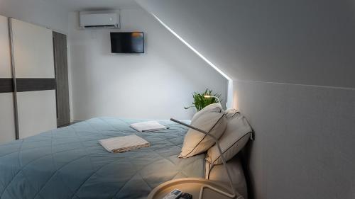 a bedroom with a bed in a room with a wall at Villa Marina in Augustów
