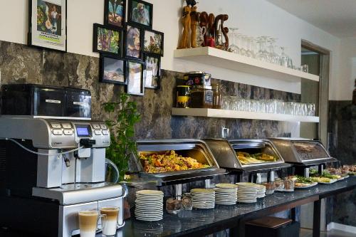 a buffet line with some food on a counter at Villa Marina in Augustów
