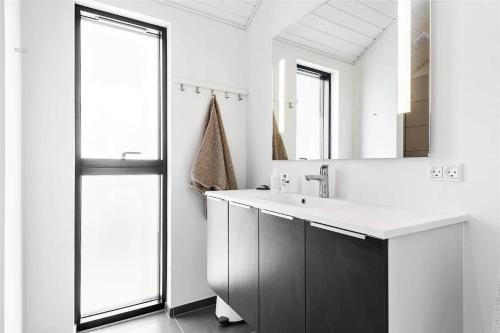a bathroom with a sink and a mirror at LK1240-Lokken-Rosavej-13 in Løkken