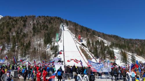 a large group of people standing on a ski slope at Apartma Maržič in Kranjska Gora