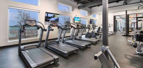 a gym with several tread machines in a row at Silk Valley - Waterfront 2B near Yas attractions in Yas Island