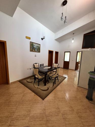 a dining room with a table and chairs at Vila Cano Boutique in Durrës