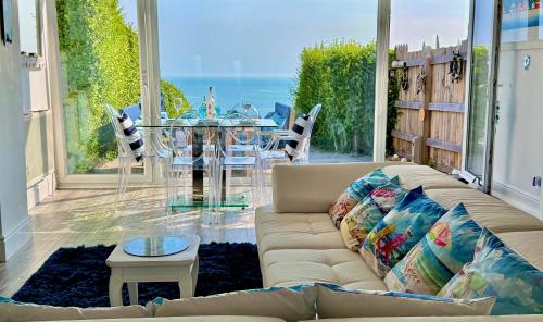 a living room with a couch and a view of the ocean at Wave Watcher Seaview Escape Near Beach & Centre in Brighton & Hove