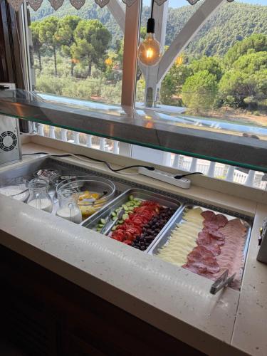 a refrigerator filled with lots of different types of food at Diaporos Hotel in Vourvourou