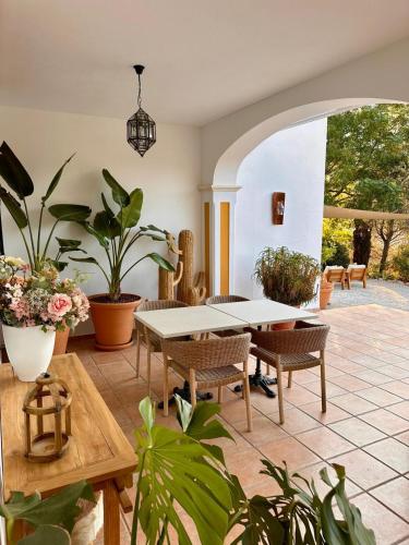 a dining room with a table and some plants at Hacienda el Tarajal in Priego de Córdoba