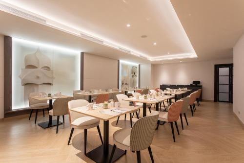 a row of tables and chairs in a restaurant at Eurostars Cristal Palace in Barcelona