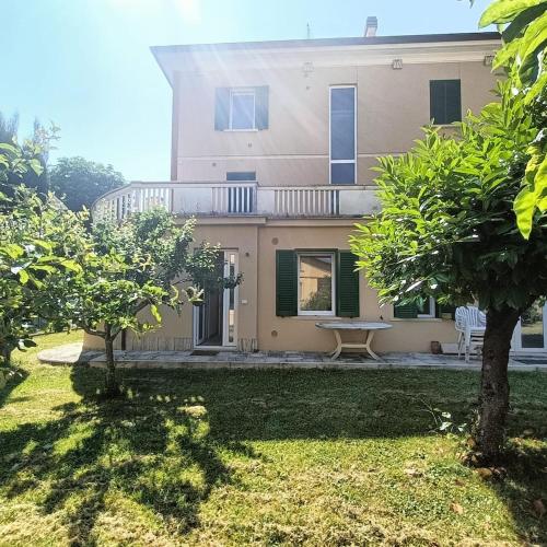 a large house with a balcony and a yard at Carpegna Green House in Carpegna