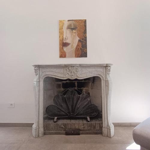 a white fireplace with a picture on top of it at Carpegna Green House in Carpegna