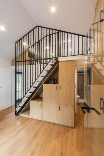 a staircase in a house with wooden floors at Hotel Jantar Wellness & Spa in Ustka