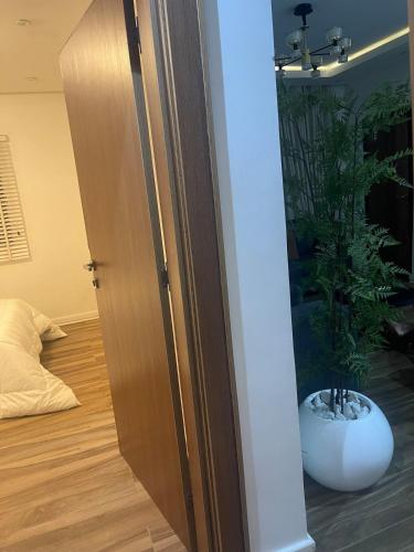 a door leading into a room with a plant in it at Modern 2-Bedroom Apt in Lifecamp in Tungan Daudu