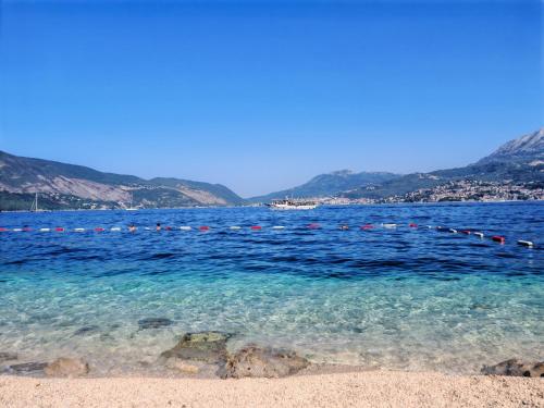 a large body of water with mountains in the background at Agape Rose Hotel in Tivat