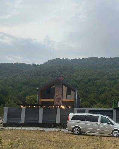 a van parked in front of a house at Pine Barn House in İsmayıllı