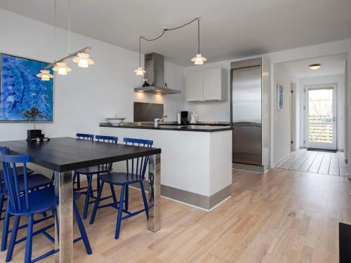 a kitchen and dining room with a table and chairs at 6 person holiday home in Væggerløse-By Traum in Marielyst