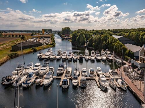 a bunch of boats are docked in a marina at Beautiful apartment with beautiful views of the lively marina in Kamperland