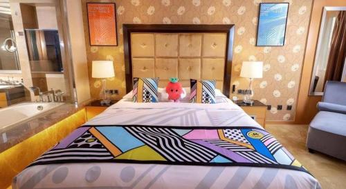 a bedroom with a large bed with a teddy bear on it at Radegast Hotel CBD in Beijing