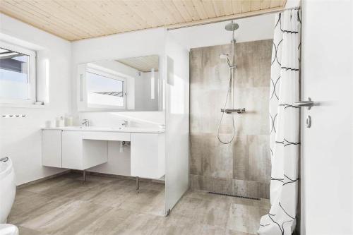 a white bathroom with a shower and a sink at LK536-Lokken-Ternevej-33 in Løkken