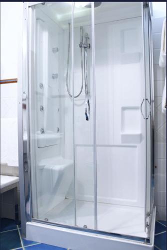 a shower with a glass door in a bathroom at Hotel Pisacane in Sapri